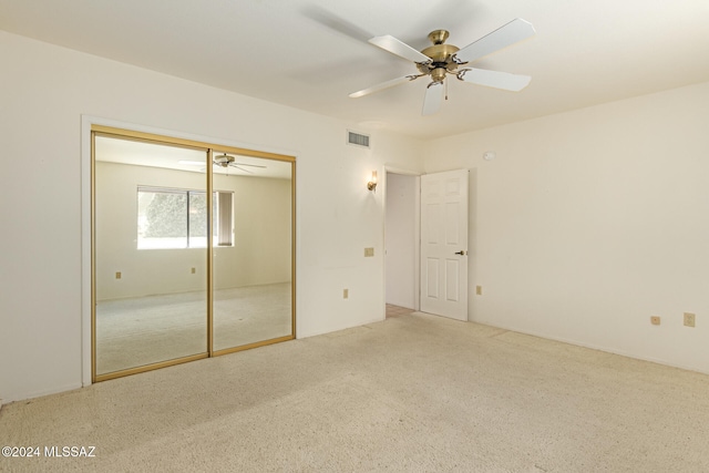 unfurnished bedroom with carpet flooring, a closet, and ceiling fan