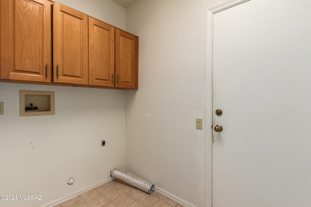 washroom featuring cabinets, hookup for a washing machine, light tile patterned flooring, hookup for a gas dryer, and hookup for an electric dryer