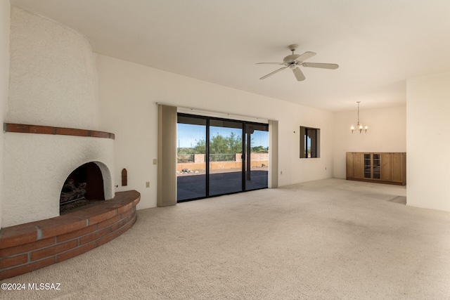 carpeted living room with a fireplace and ceiling fan with notable chandelier