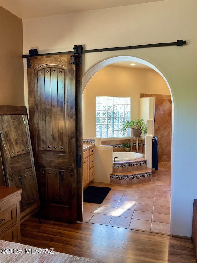 5550 W Open R Pl, Tucson, AZ 85713 - bathroom with a garden tub, wood finished floors, and vanity