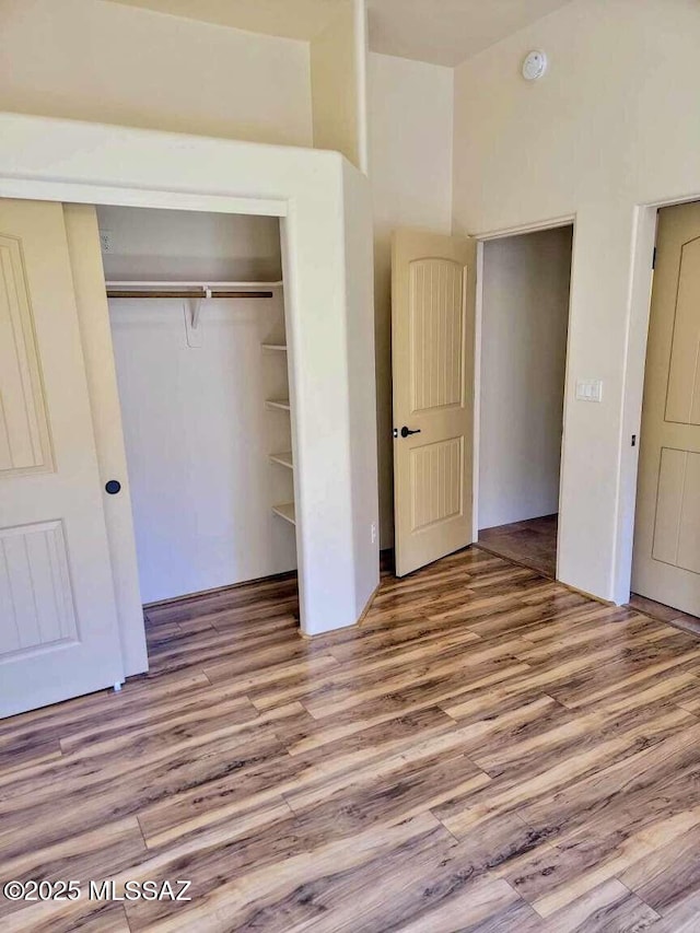 5550 W Open R Pl, Tucson, AZ 85713 - unfurnished bedroom featuring a closet and wood finished floors