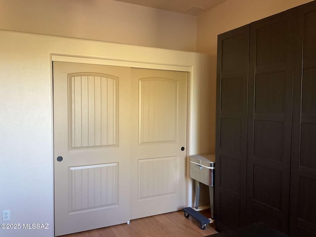 5550 W Open R Pl, Tucson, AZ 85713 - unfurnished bedroom featuring a closet and light wood-type flooring