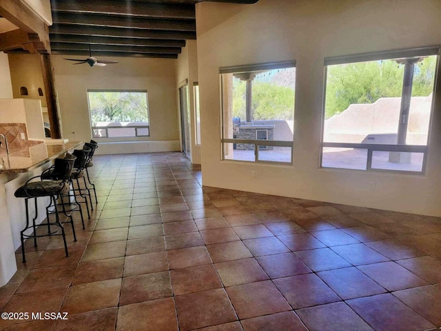 5550 W Open R Pl, Tucson, AZ 85713 - dining room with beam ceiling, ceiling fan, and dark tile patterned flooring