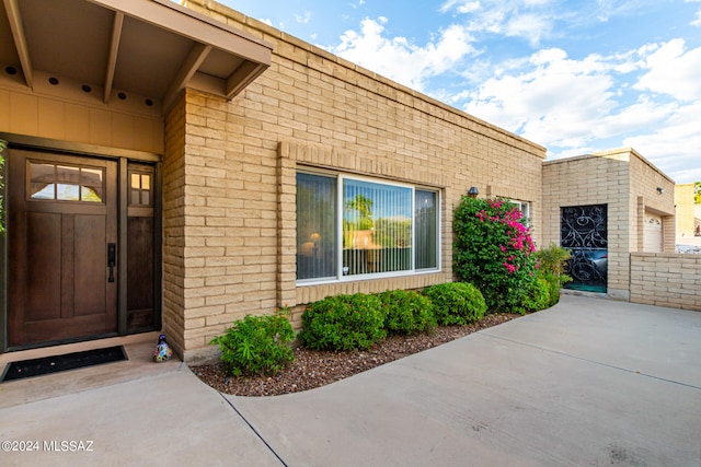 view of exterior entry with brick siding