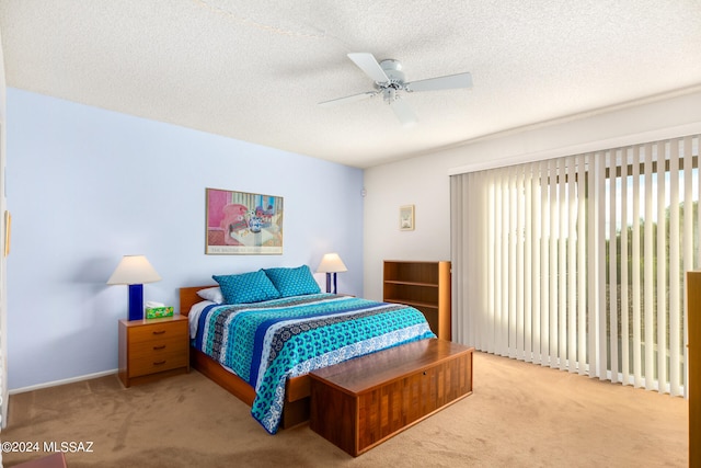 carpeted bedroom featuring a textured ceiling and ceiling fan