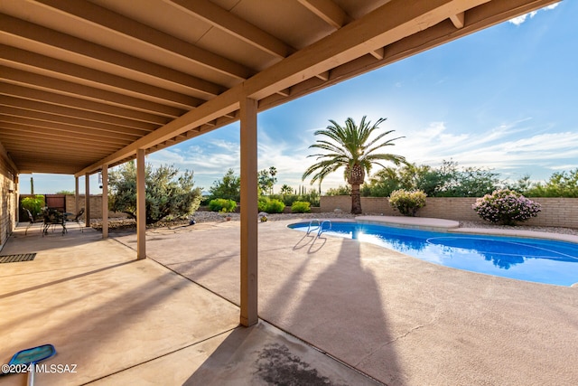 view of swimming pool featuring a patio area, a fenced backyard, and a fenced in pool