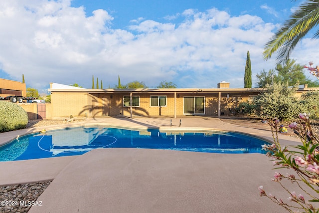 pool featuring a patio area and fence