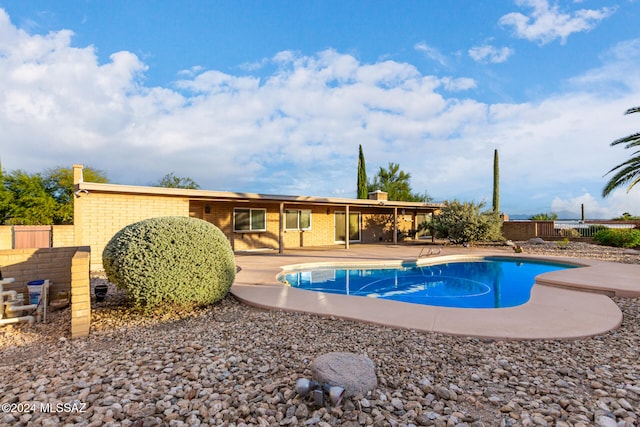 view of pool with a fenced in pool, a fenced backyard, and a patio