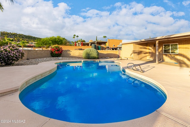 view of swimming pool with a patio area, a fenced backyard, and a fenced in pool