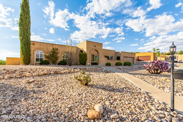 pueblo-style house with a garage