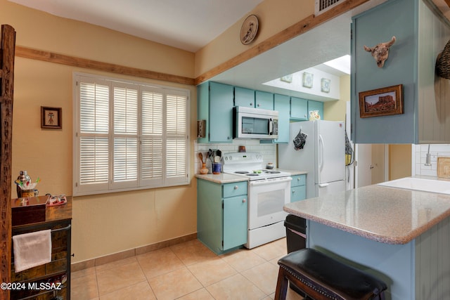 kitchen featuring tasteful backsplash, white appliances, light countertops, and blue cabinetry