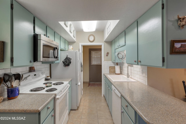 2798 S Camino Selva, Green Valley, AZ 85622 - kitchen featuring a sink, decorative backsplash, white appliances, light tile patterned floors, and green cabinets