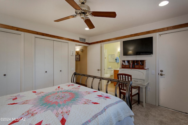 carpeted bedroom featuring a ceiling fan, recessed lighting, visible vents, and two closets