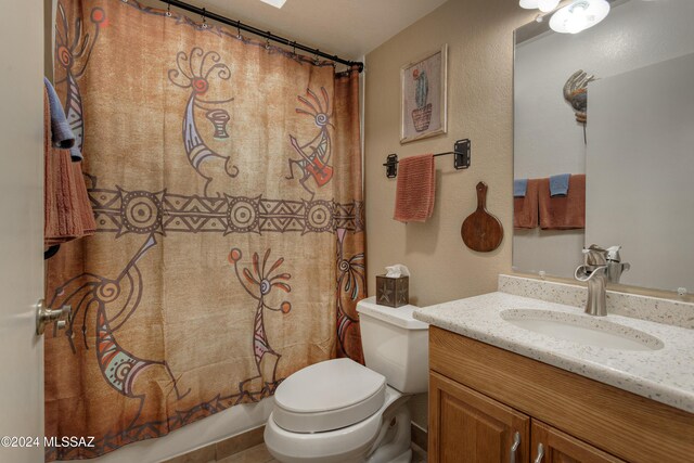 2798 S Camino Selva, Green Valley, AZ 85622 - bathroom with a textured wall, toilet, vanity, and shower / bathtub combination with curtain