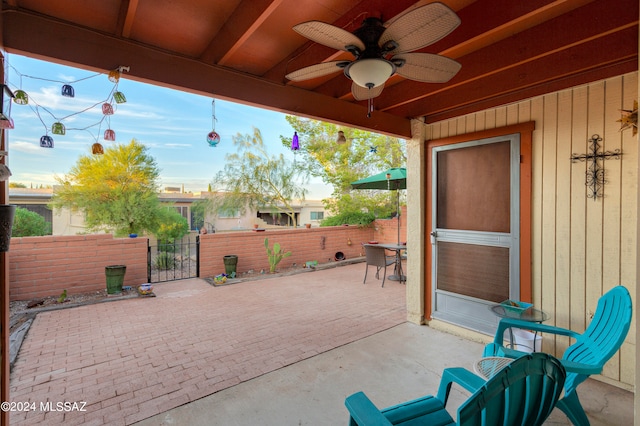 view of patio featuring fence and ceiling fan