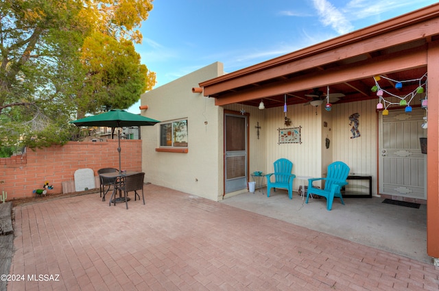 view of patio / terrace with a ceiling fan and fence