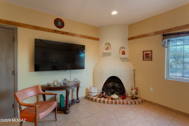 living area with light tile patterned floors, recessed lighting, a fireplace, and baseboards