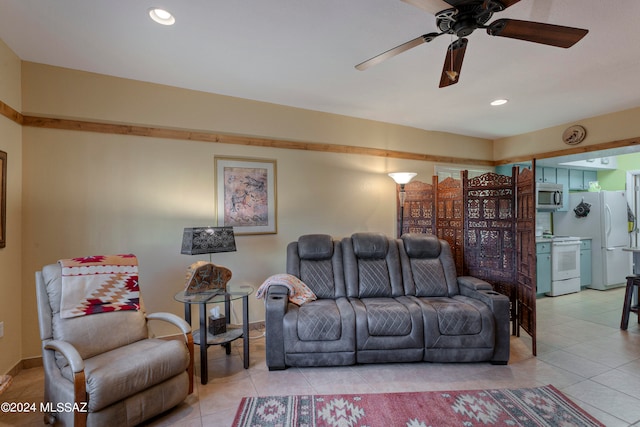 living room with light tile patterned floors, baseboards, a ceiling fan, and recessed lighting