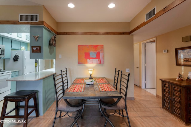 dining space with light tile patterned flooring, visible vents, and recessed lighting