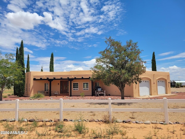 pueblo-style home with a garage