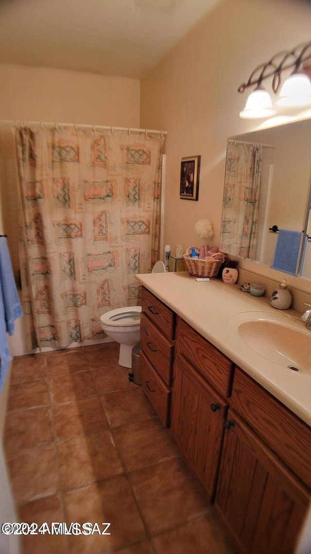 bathroom with tile patterned flooring, curtained shower, vanity, and toilet