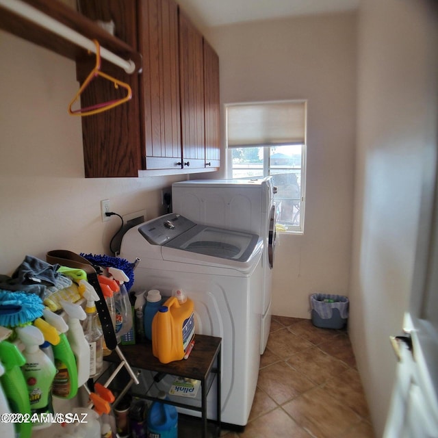 washroom with cabinets, separate washer and dryer, and light tile patterned floors