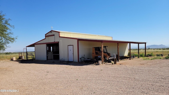 view of outbuilding featuring a mountain view and a rural view