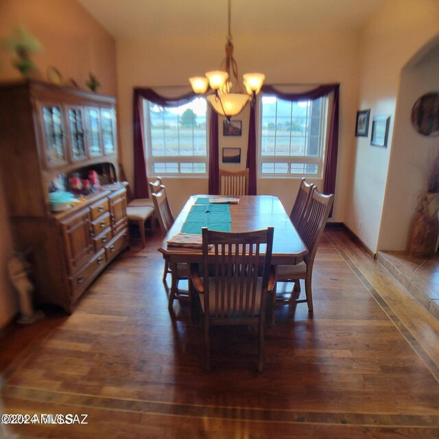 dining area featuring a notable chandelier and dark hardwood / wood-style flooring