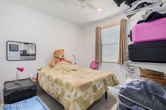 bedroom with ceiling fan and wood-type flooring