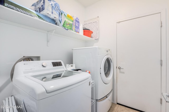 washroom featuring light tile patterned floors and separate washer and dryer