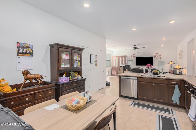 kitchen with light tile patterned floors, stainless steel dishwasher, dark brown cabinets, and ceiling fan