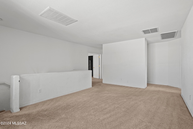 empty room featuring light carpet