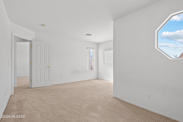 spare room with light carpet