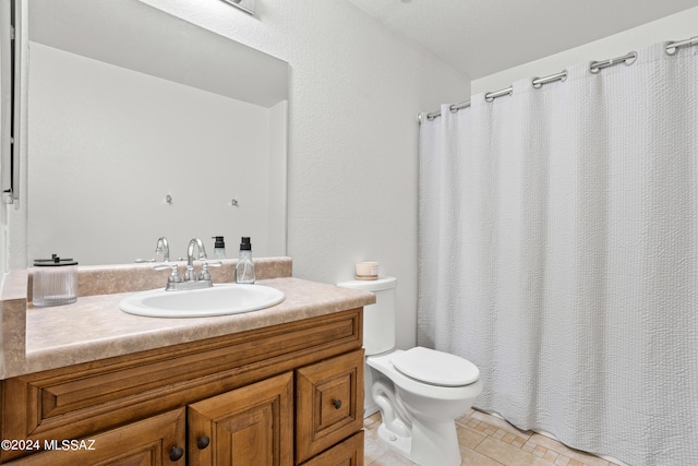 bathroom featuring vanity, toilet, and tile patterned flooring