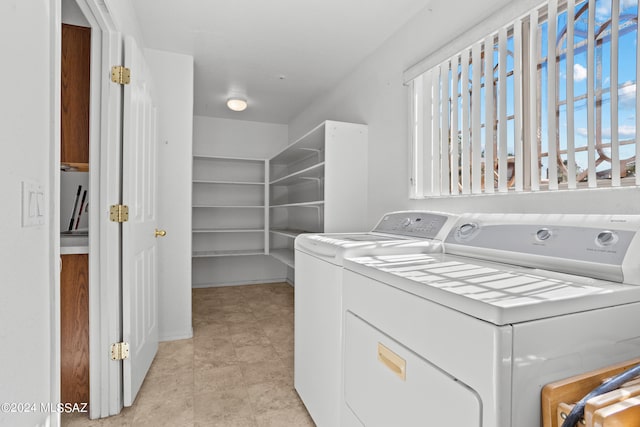 clothes washing area featuring separate washer and dryer