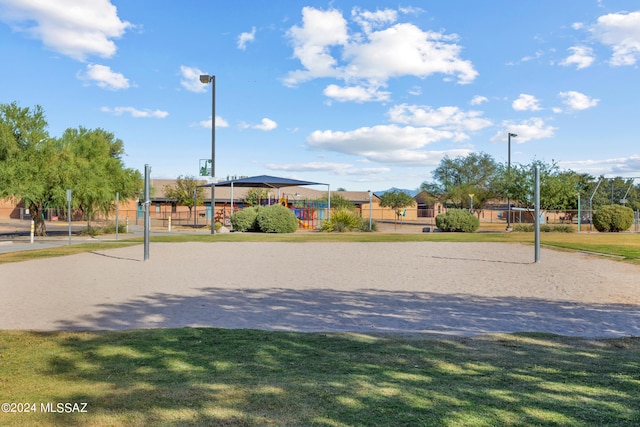 view of home's community featuring a yard and volleyball court