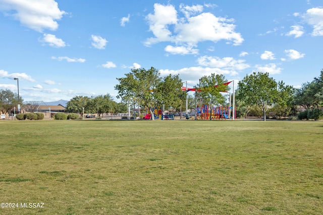 view of home's community with a playground and a yard