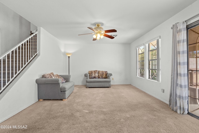 unfurnished room with light carpet and ceiling fan