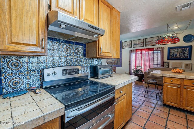 kitchen with dishwasher, tile counters, tile patterned flooring, backsplash, and sink