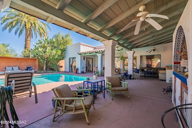 view of swimming pool with outdoor lounge area, a patio area, and ceiling fan