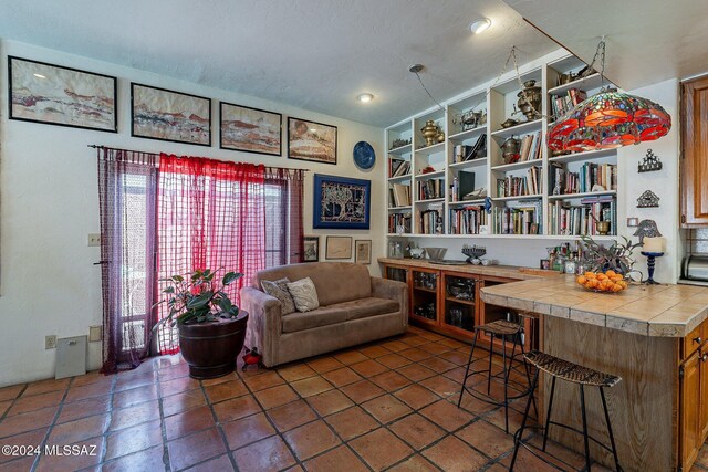 living area with tile patterned floors and a textured ceiling