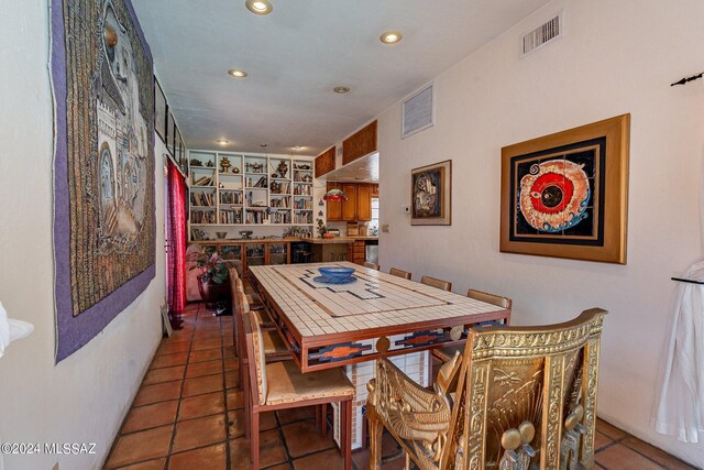 living room featuring vaulted ceiling with beams and tile patterned flooring