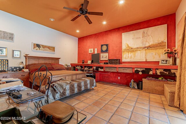 tiled bedroom with ensuite bathroom, high vaulted ceiling, and ceiling fan