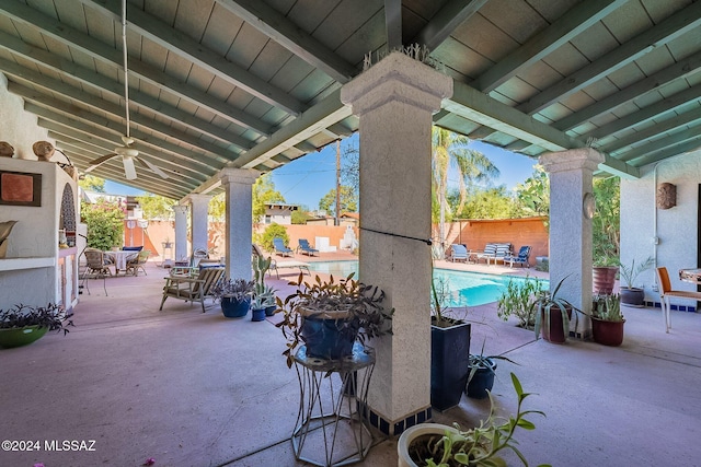 view of patio / terrace with a fenced in pool and ceiling fan