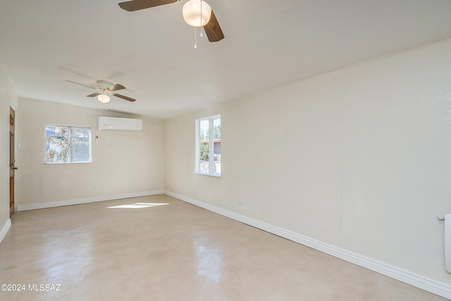 spare room featuring a wall mounted air conditioner, a wealth of natural light, and ceiling fan