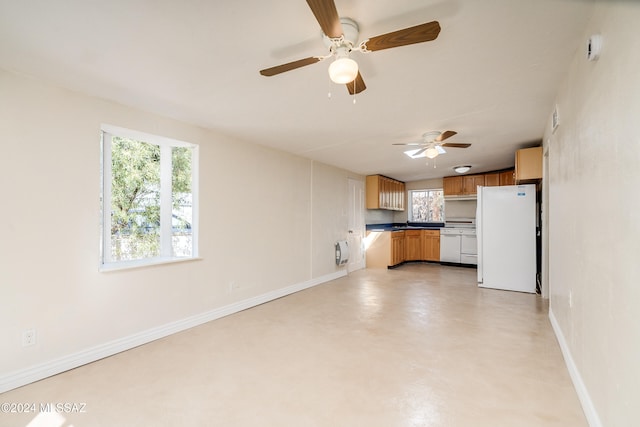 interior space featuring ceiling fan and plenty of natural light