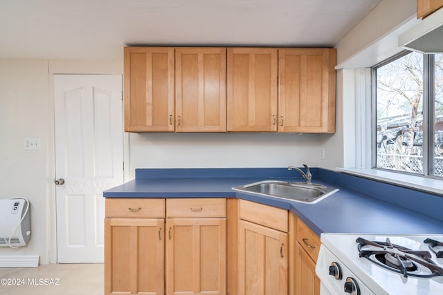 kitchen featuring white range oven, sink, and heating unit