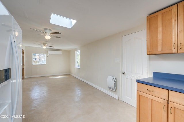 kitchen with a skylight, ceiling fan, white refrigerator with ice dispenser, heating unit, and an AC wall unit