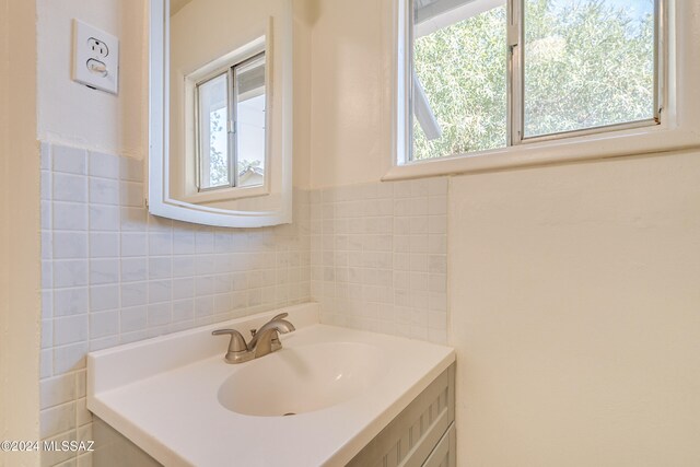 bathroom featuring vanity, tile walls, and a wealth of natural light