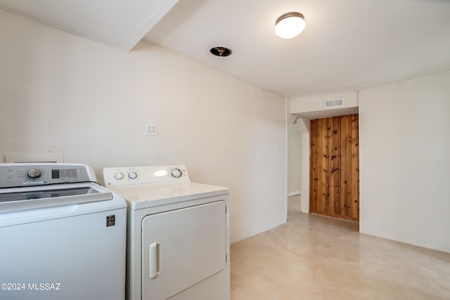 clothes washing area featuring separate washer and dryer